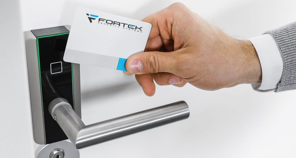 electronic lock with hand holding Fortek card fob